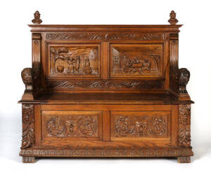 HALL SEAT: English oak with handsomely carved panels & recumbent lion arm rests, late 19th or early 20th century. W 122cm, D 48cm, H 110cm