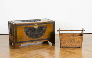 A carved Chinese camphor wood blanket box (top split); plus a carved magazine rack.