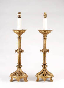 A pair of gilt metal gothic style candlestick lamps, French 19th century
