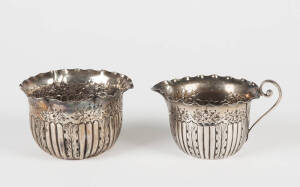 An antique sterling silver cream jug and sugar bowl
