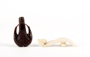 A carved jade belt hook, 10cm long and a carved horn snuff bottle and stopper carved as two birds, 9cm high