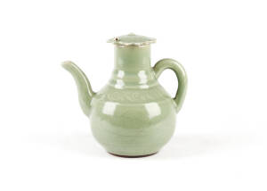 A carved celadon glazed stoneware wine ewer and cover, 19cm high