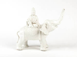 A Blanc-de-Chine figure of Guanyin seated on the back of an elephant, 25cm high