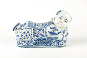 A Chinese blue and white and pink porcelain boy pillow