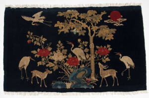 Two Chinese deep blue ground bull rugs decorated with animals and bird