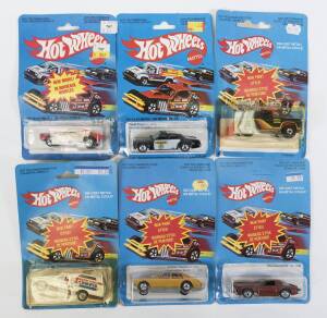 HOTWHEELS: group of Vintage early 1980s model cars including Bywayman (2509); and, Hard-to-find transitional Brown base Variation Minitrek (1697); and, Omni 024 (1692). All mint and unopened on original cardboard blister packs. (57 items approx.)