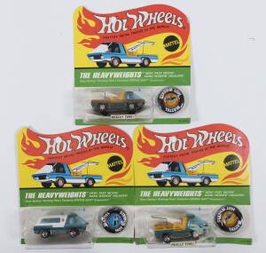 HOTWHEELS: 1970 group of Redline ‘The Heavyweights’ including Tow Truck (6450) – Spectral Flame Olive Cab; and, Ambulance (6451) - Spectral Flame Aqua; and, Tow Truck (6450) – Spectral Flame Aqua Cab. All mint and unopened in original flame blister packs.