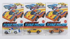 HOTWHEELS: 1975 group of Redline ‘Flying Colors’ including Ramblin’ Wrecker (7659) – White; and, Mustang Stocker (7644) – Yellow; and, Chevy Monza 2+2 (7671) – Orange. All mint and unopened in original rectangular white blister pack. (3 items)