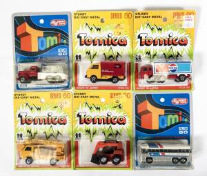 TOMICA: Group of blister pack model cars including Greyhound Bus (F49); and, Jobson SDK8 (37); and, Nissan Caball (87). All mint and unopened on original cardboard card (40 items).