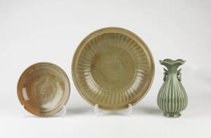 Two circular celadon plates 36 and 25cm diameter and a ribbed celadon ovoid vase 26cm high
