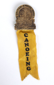 1930 1st BRITISH EMPIRE GAMES IN HAMILTON, Official's badge with yellow ribbon "CANOEING", 28x33mm.