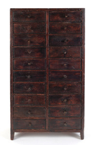 A miniature chest of 20 drawers, stained pine, drawers fitted with various compartments, circa 1900