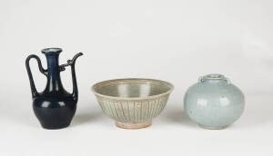 A ribbed celadon circular bowl, 15th/16th Century,&nbsp;a lavender blue grey jar 15cm high and a dark blue glazed ewer 18cn high
