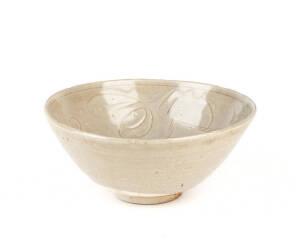 A carved celadon glazed circular lotus bowl, 13th/14th century