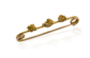 A gold bar brooch set with three gold nugget specimens, 19th century