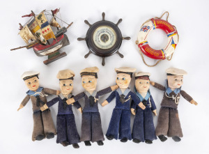 Maritime group comprising six sailor dolls, ships wheel barometer, Strathmore life saver ornament and Drake galleon ornament, 20th century