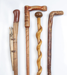 Four assorted walking sticks including Maori carved and crocodile carving, 20th century