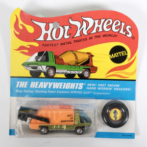 HOTWHEELS: 1971 Redline ‘The Heavyweights’ Waste Wagon (6192) – Spectral Flame Olive Cab with orange plastic trailer. Mint and unopened in original flame blister pack.