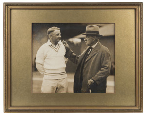 Don Bradman in conversation with Charles Bannerman during the 1930 cricket season; original sepia photograph. 25 x 30cm. Framed and glazed overall 39 x 49cm.