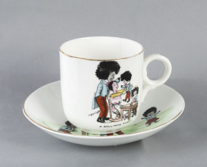 A Golliwog Family cup and saucer set, circa 1950; the cup (vertical hairline crack) shows the family collecting their bats and the saucer depicts them playing cricket in the yard. Believed to be by Grimwades; saucer 13.5cm diameter; cup 7cm tall. (2 items