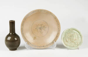 A Vietnamese circular bowl decorated with a central sprig, 28cm diameter, and a dark green glaze bottle vase 21cm high and a lobed circular stand 18cm high