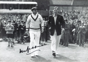 Original press photograph 12 x 18cm) of Australia's Don Bradman and England's Norman Yardley as they emerge from the pavilion onto the cricket pitch - 22 July 1948, the first day of the Fourth Test, at Leeds. With original signature of Don Bradman. Framed