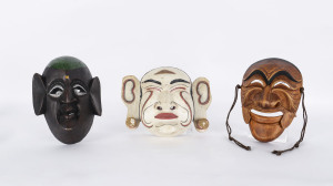 Three masks, carved and painted wood, Japanese and African, 20th century