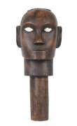 A carved wooden head with pearl shell inlay eyes, Sulawesi, early 20th century