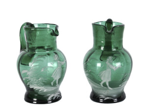 A pair of Mary Gregory green glass cream jugs, American, 19th century