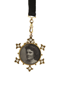 A late Victorian 9ct gold and seed pearl double sided photo pendant on silk chain