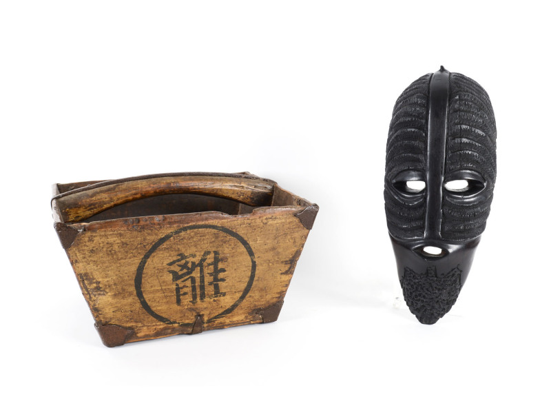 An African carved wooden mask and a Chinese rice measure, 19th/20th century