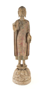 A Chinese polychrome finished carved marble statue of a standing Buddha on a lotus plinth