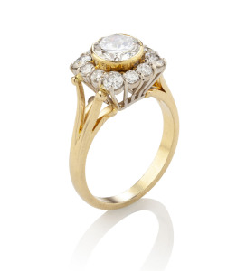 18ct gold ring set with a 1.3 carat diamond surrounded by 12 brilliant cut shoulder diamonds