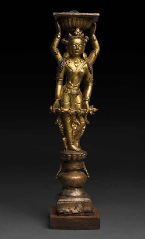 Tibetan Densatil gilt-bronze image of an Offering Goddess (Chopay Lhamo), 14th/15th century