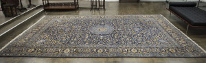 A large Persian rug, hand knotted with blue medallion motif, 20th century