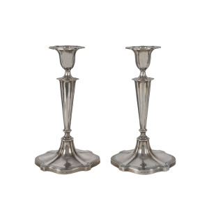A pair of sterling silver candlesticks, a matched pair by Walker and Hall, early 20th century
