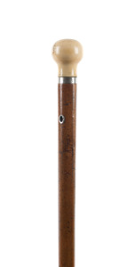 A walking stick with ivory top and cane shaft, 19th century