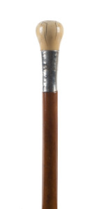 A walking stick, large ivory handle with silver collar and cane shaft, 19th century