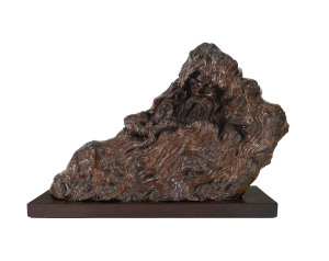 A Chinese burl wood carved immortal, with fitted wooden stand, early 20th century