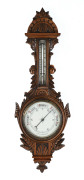 An English banjo aneroid barometer in oak case, 19th century