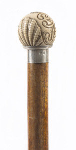 A walking stick with carved ivory handle, silver collar and blackwood shaft, 19th century