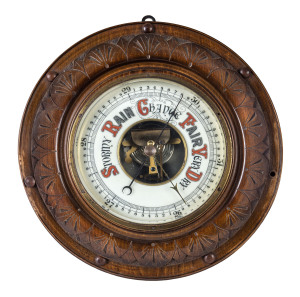 An aneroid barometer, carved circular timber case with enamel dial, 19th century