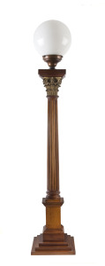 A Corinthian column standard lamp with spherical glass shade, blackwood with ormolu capital, early 20th century