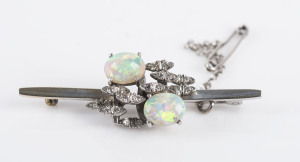 An Australian 18ct white gold bar brooch set with two solid milk opals and diamonds