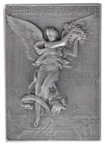 Winner's Plaque in solid silver, for the IXth Shooting Championship of High Schools & Colleges, with "IXME CHAMPIONNAT DE TIR DES LYCEES ET COLLEGES" engraved in the panel at lower right and the name of the recipient, "R. JUGE" at upper right. 55gms, 42 x 60mm. By F. Vernon. The obverse image depicts a winged goddess scattering laurel branches over the Paris Exposition grounds. Reverse: Victorious athlete standing on the podium, the Parthenon in the background. Awarded for the shooting com