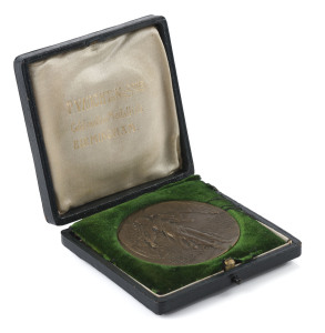 Donor's medal, Bronze, 50mm in original greenish-black presentation case by P. Vaughton & Sons, Birmingham; the case with gilt embossed lettering on the lid "OLYMPIC GAMES OF LONDON, 1908. DONOR."The medal, designed by Bertram Mackennal, depicts on the obverse: A Greek four-horsed chariot. Two men side by side: the driver and the judge, who is ready to reward the winning athlete the victory palm. The reverse: Winged figure of Fame standing on the globe between legend.