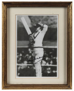 DON BRADMAN, nice signature on black & white image of Bradman getting ready to face a bowler. Framed & glazed; overall 28 x 22cm.