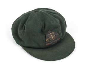 STAN McCABE'S 1936-37 AUSTRALIAN BAGGY GREEN TEST TEAM CAPgreen wool, coat of arms worked with gold and silver wire and coloured silk, Farmer's Sydney label inside crown inscribed in ink S.J.McCabe. A HIGHLY IMPORTANT AND ROMANTIC PRIMARY OBJECT ASSOCIATED WITH ONE OF AUSTRALIA'S FINEST BATSMEN.