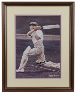 DON BRADMAN reproduction photograph of the young star showing his follow-through position, signed, framed & glazed; overall 57 x 45cm.