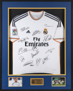 REAL MADRID FOOTBALL CLUB: 2013/14 Home Jersey Champions League Winning Season, signed by 14 members of the squad; framed & glazed, overall 104.5 x 85cm.